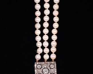ANTIQUE DIAMOND & PEARL CHOKER NECKLACE | Designed as a triple stand pearl necklace, the antique rectangular clasp set with a central approximately 1.05 carat old mine brilliant cut diamond flanked by four half-carat old mine brilliant cut diamonds all set in concentric circles of antique full cut melee diamonds; 14 in., 67.6g; clasp 1 x 3/4 in.