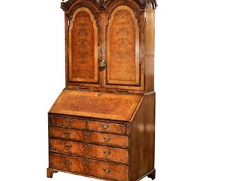 QUEEN ANNE INLAID WALNUT SECRETARY BOOKCASE | English, early 18th century, upper structure with double bonnet top and molded doors revealing an elaborate fitted interior, the lower case with cross-banded slant-front revealing a leather writing surface and similarly outfitted interior, over two short and three graduated drawers raised on bracket feet
h. 82-1/2 w. 43-1/4 d. 24 in.