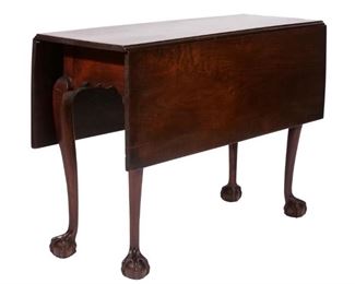 AMERICAN CHIPPENDALE DROP-LEAF TABLE | Late 18th century, probably Philadelphia, mahogany, with rectangular top over scalloped apron resting on angular cabriole legs ending in ball and claw feet
h. 27-1/2 w. 40-1/4 d. 14 in. (with leaves down)
overall: d. 40 in. (with leaves open)
Dining tables of this size are exceedingly scarce. This example is in its original state retaining its original hinges and glue blocks