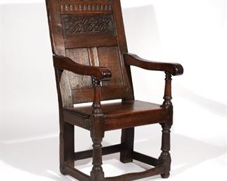 17TH C. CARVED OAK WAINSCOT CHAIR | Having rectilinear form, carved backrest with strap work recessed panels, shaped arms, resting on ring and block supports,continuing to boxed stretcher
h. 46 w. 23 d. 27 in.