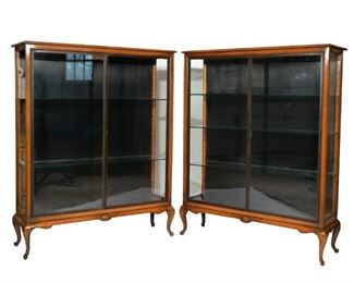 PAIR QUEEN ANNE DISPLAY CABINETS OF SMALL SIZE | Mid-20th C., double full-length glass doors, resting on scalloped apron continuing to short angular cabriole legs. adjustable glass shelves
h. 39 w. 36 d. 17 in.