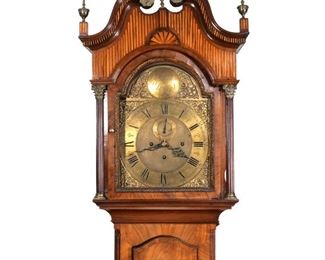 GEORGE III INLAID MAHOGANY TALL CASE CLOCK | Late 18th/ early 19th century, George Brigg Clapham, England, broken swan's neck pediment with profuse inlay, engraved brass dial with Roman numeral chapter ring, hood with engaged Corinthian columns, the case with door having a central inlaid shell and checkerboard string inlay flanked by three-quarter columns, the lower section with matching inlay and ogee bracket feet
h. 86 (over finial) w. 21-1/4 d. 10-1/2 in.
Geo. Brigg Clapham, mentioned ibn Britten's, "Old Clocks and Wathes and Their Makers" pg. 352