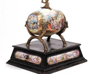 VIENNESE ENAMEL & SILVER BARREL FORM CLOCK | Late 19th / early 20th century, in the form of a barrel enameled with Bacchic scenes, mounted on an ebonized base with a drawer and enameled panels, with Bacchus finial, N.B. impressed marks on barrel rim
h. 6-1/2 w. 5-1/2 d. 6-3/4 in.