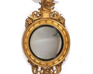 19TH CENTURY GILT EAGLE BULL'S EYE MIRROR | Crested by a carved eagle
h. 44 w. 24 d. 8 in.