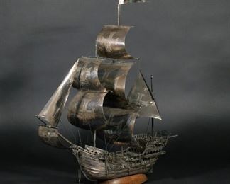 PORTUGUESE .833 SILVER MODEL SHIP | Depicting a man-o-war, with post 1938 Porto .833 hallmarks, mounted on a wooden base, 90 ozt total (including base)
h. 23 w. 21 d. 7-1/2 in.