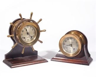 (2PC) CHELSEA SHIP BELL AND WHEEL CLOCK'S  |  [1] Chelsea Ship's Bell Clock, brass-cased, with a 3-1/2in. Arabic numeral silvered dial marked Chelsea Ship's Bell eight-day lever-escapement ship's bell striking movement mounted in a mahogany base, h 6-1/4in. Serial No: 216671 dated: July 9th 1935. [2] The Yacht wheel clock is called the "mariner or pilot" depending on when it was made. a 3-1/2in. Arabic numeral silvered dial marked Chelsea Ship's Bell eight-day lever-escapement ship's bell striking movement mounted in a mahogany base. h-10in.