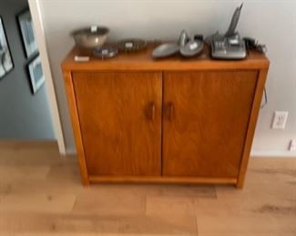Small cabinet with telephone, bowls and accessories