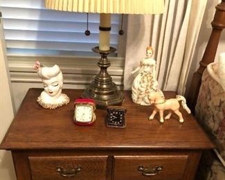 Small chest with drawers (26”W, 17”D, 24”H) + lady head vase, vintage alarm clocks & one of several brass table lamps