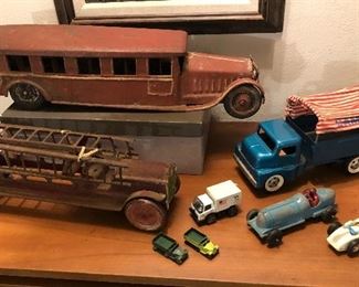Old metal toy cars & trucks: Cor-Cor 24" pressed steel school bus, fire truck with ladders, Hubley race car, Structo “Camper” truck with cloth canopy, small Lesney trucks