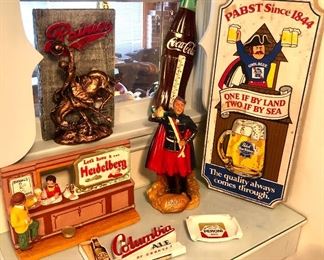 More vintage beer advertising: Heidelberg chalkware wall plaque & statue, Columbia Ale sign, plastic Rainier bucking bronco, tin litho Coke thermometer (missing thermometer), wood Pabst sign, Peroni tip tray