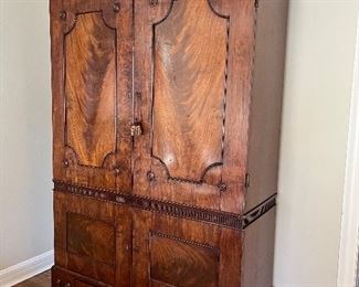 $2800. obo Stunning flame mahogany antique armoire originally from David Weatherford. Three drawers along the base, two "secret" compartments on the end at the base . Inside has 5 shelves and a small hole for wires if you want to add lighting. 57.75"w x 24"d x 87"to the flat top and 97" to the top of the finial pieces.