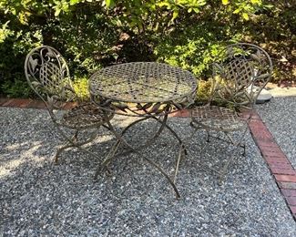 $140. obo Three-piece iron Bistro set with some as found where the metal is rusted/. Table is 30" h and 28" diameter.