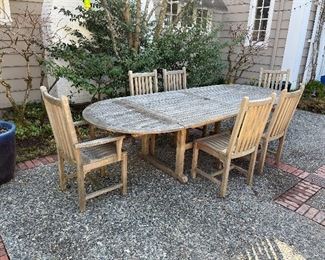 $1600.obo Kingsley-Bate teak dining table and six chairs. Table is 122"l as shown x 46"w x 29"h. Ends removed reveal a 76"long table.