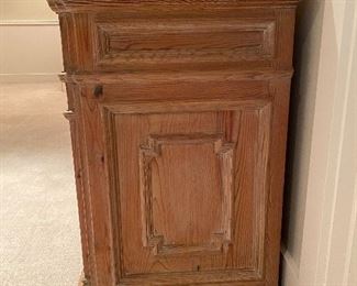 end of the piece showing carved detailing