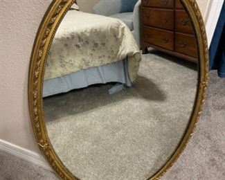 Oval wood mirror.                                                26”w 38” t.                                                                   $75.00