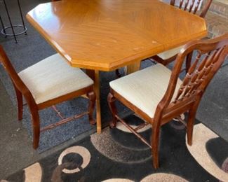 Wooden kitchen table w leaf & 4 chairs.   Table: 42”w 42”d 30”t. Leaf: 18”w 42”d.   Chairs: 19”w 17”d 38” t, 18” flr to seat.     $125.00