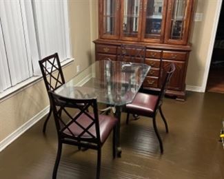 Scalloped glass top table with metal base and (4) metal chairs.                                  Table: 30”w 50” L 28.75” T.                                $150.00