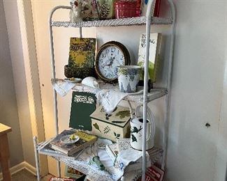 White metal mesh shelf 
Gardening items 
Flower pots 
Garden books 