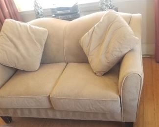 Neutral suede-like loveseat