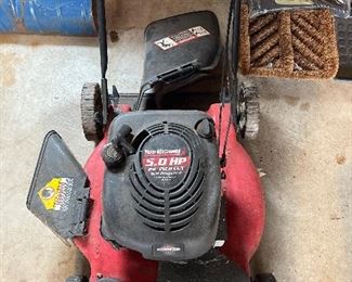 Garage:  The self-propelled 5 HP "Yard Machine" mower has a 22" side discharge and a 6-position height adjustment.  It is Model 12A-268BG352.