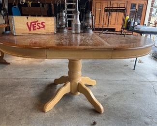 Garage:  This 42" round pedestal table converts to an oval (as shown) once the 18" leaf is included.  When it is oval, it measures 42" x 60."  The wooden St. Louis VESS soda crate (holds 12) and the St. Louis Post-Dispatch metal newspaper rack on the right are also for sale.  A closer photo of the three center items follows.