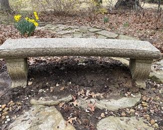 Outside:  A three-piece concrete garden bench has a subtle curve.  Bring help to remove it upon purchase!