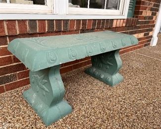 Front Porch:  A three-piece concrete bench has hummingbirds on the top and sides.