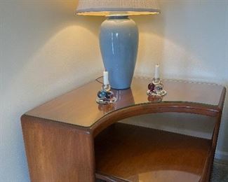 Living Room:  A vintage HEYWOOD-WAKEFIELD step corner (boomerang) table also has a protective glass top.  The blue lamp is the second of two available.  A pair of glass grape candlesticks is also shown.