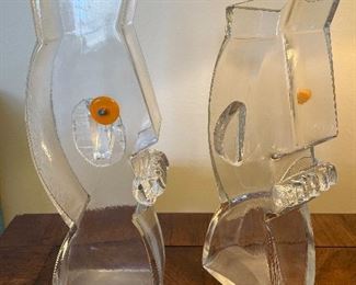 Living Room:  A pair of unique SAM STANG glass vessels is shown.  Each one has one orange eye and one ear.