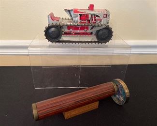 Dining Room:  A circa 1950 tin wind-up MARX 5 climbing tractor (8-1/4") hovers above a fun wood/brass kaleidoscope.  The tractor does have both of its treads.