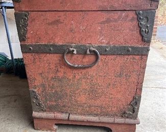 Garage:  This is a view of one side of the antique chest.  Notice the forged iron detail on the dome, the corners, and the iron ring.  