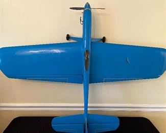 Dining Room:  A model airplane with a cockpit and 51" wing span has its landing gear attached and is [almost] ready for take off! A box of nearby airplane motors and other items is included with the plane price.