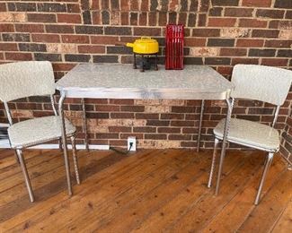 Sun Room:  A 1950's retro grey/chrome table (40" x 24") and chair set is by Daystrom Corp.  The Formica table top and vinyl chairs have a "marbleized" look.  It is the perfect set for a small apartment!  The DANSK fondue pot and fondue forks are also for sale and priced separately.