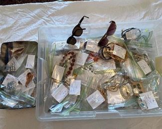 Over 90 bags of newer and costume jewelry, sterling, watches, and sunglasses.   Included are pieces by:  Trifari and Trifari Crown; Jomex; Renoir; Weiss; Pauline Rader; Kramer; J.J.; as well as Seiko and Gucci watches (batteries needed).  The small box of jewels is in the dining room; the larger box is in the living room.