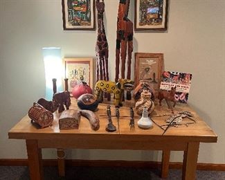 Family Room:  Carved wooden giraffes oversee a smaller wood carved elephant, horse, rhinoceros, colorful painted gourds,  a North American Indian  framed sand art, and more.