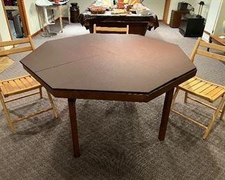 Lower Level:  The folding poker table now has its two-piece padded cover in place.  This allows the table to now be used for card games, board games, or dinner!