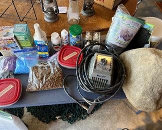 Garage: An assortment of fish pond supplies is shown including a MATOLA pump (manual is with the cashier) and a large faux rock.