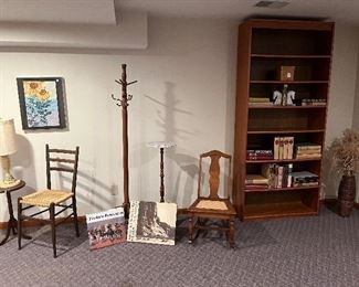 Family Room:  A seven-shelf TEAK bookcase (36" wide x 12" deep x 83'' tall) is to the right of vintage chairs, a coat rack, and round stands.  The teak bookcase displays several  Heritage Press books, many are Heritage first editions and are dated 1930-1960.  On the floor are two large books:  FREDERIC REMINGTON (Peter Hassrick) and PORTRAITS from NORTH AMERICAN INDIAN LIFE (Intros by A. D. Coleman and T.C. McLuhan).  More quality books are in the bookcase.