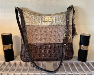 Dining Room:  A BRAHMIN cross-body is flanked by two bottles of CHANEL No. 5.