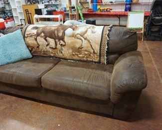 brown couch, pillow, horse blanket