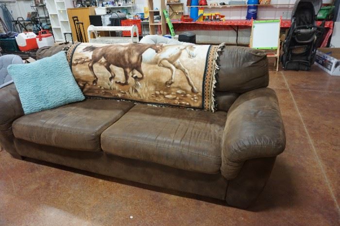 brown couch, pillow, horse blanket