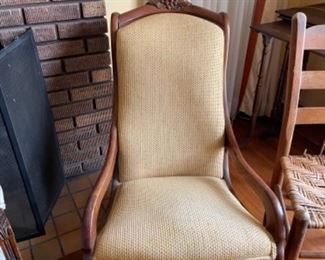 Carved wood and upholstered rocking chair. 