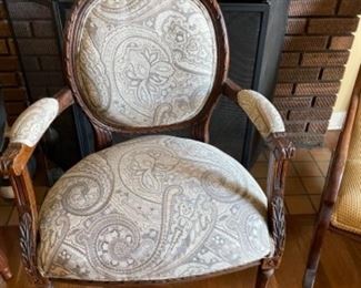 Carved wood and upholstered vintage arm chair. 