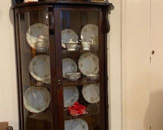 BOW FRON OAK CHINA CABINET WITHMIRROR TOPPER SHOWING AN ELECTRIC MANTLE CLOCK, ASIAN ACCESSORIES