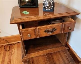 Open view of the table stand with hatch open and drawer open.