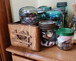 Antique ez seal mason jars full of buttons stored in Sewing cabinet drawer