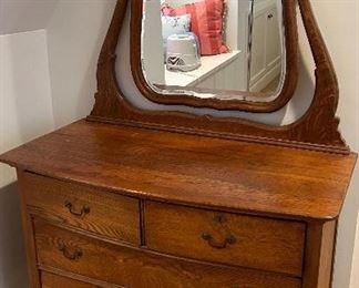 Antique wood 4 drawer dresser on wheels with beveled mirror 
42”w x 21.5d x 33h s/ mirror $165