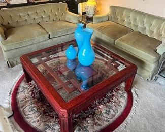 Small Living room sofas by Lloyds of Long Beach. Beautiful glass table , oriental rugs