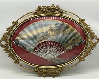 Hand Painted Fan with European Landscapes
Bound by MOP Stems with Long Gold & Blue Tassels 
Attached to Ends
The Antique Fan is held behind a convex glass exterior and wrought gilt metal flower fame
25.5x19x11.5
