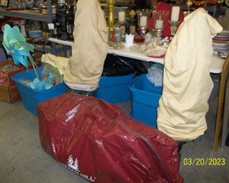 Those 2 items covered are topiaries.  Balsam Hill Christmas tree in the red bag.